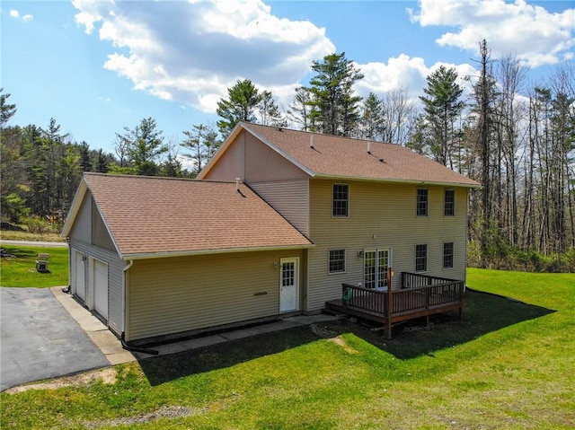 11827 Lando Ln, Corning, NY 14830 - back of property with a deck, a yard, a garage, and roof with shingles