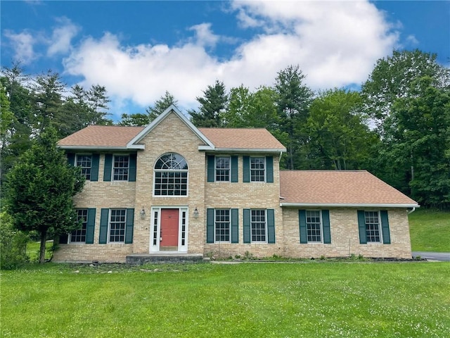 11827 Lando Ln, Corning, NY 14830 - colonial inspired home featuring brick siding, a front lawn, and roof with shingles