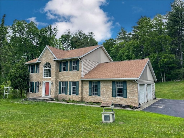 11827 Lando Ln, Corning, NY 14830 - colonial home featuring a shingled roof, a front yard, an attached garage, driveway, and brick siding