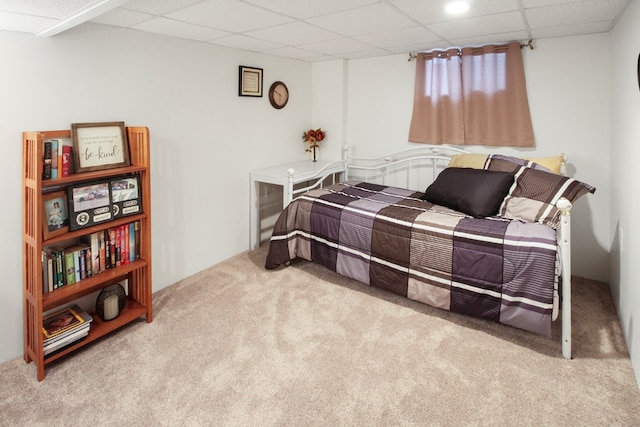 carpeted bedroom with a drop ceiling