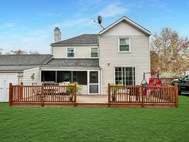 back of property with a wooden deck and a yard