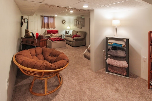 sitting room featuring light carpet and a paneled ceiling