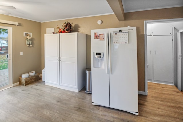 kitchen with crown molding, white refrigerator with ice dispenser, white cabinets, and light hardwood / wood-style flooring