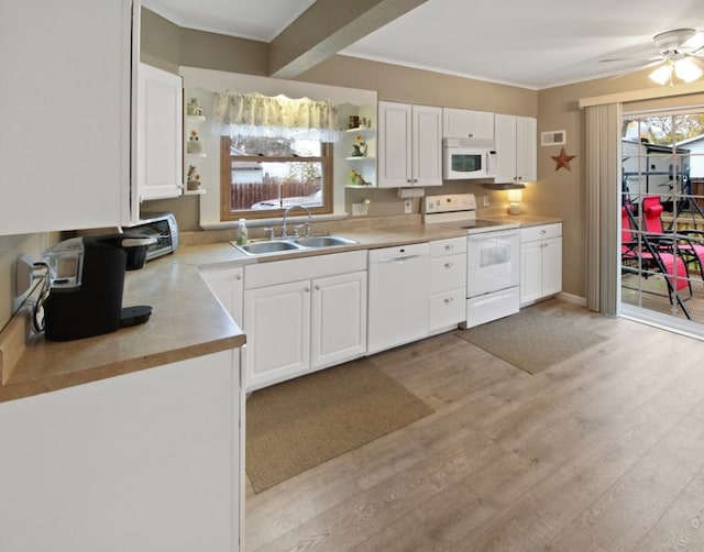 kitchen with white cabinetry, sink, and white appliances