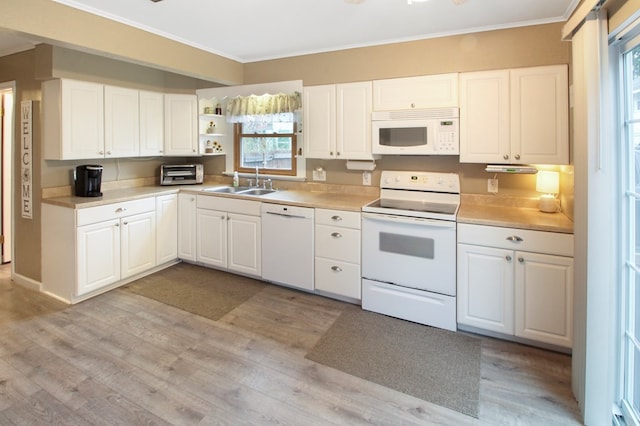 kitchen with sink, crown molding, white appliances, light hardwood / wood-style floors, and white cabinets