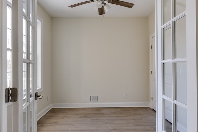 spare room featuring light hardwood / wood-style floors, french doors, and ceiling fan