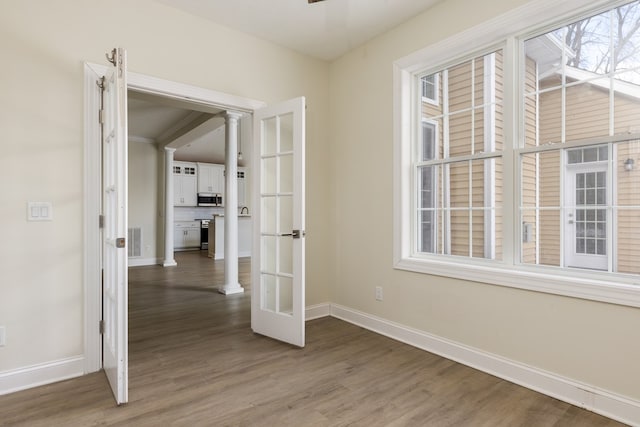 unfurnished room featuring french doors and wood-type flooring