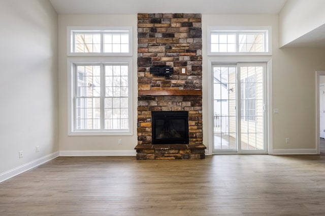 unfurnished living room with hardwood / wood-style flooring and a fireplace