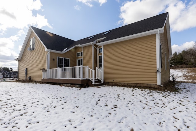 view of snow covered rear of property