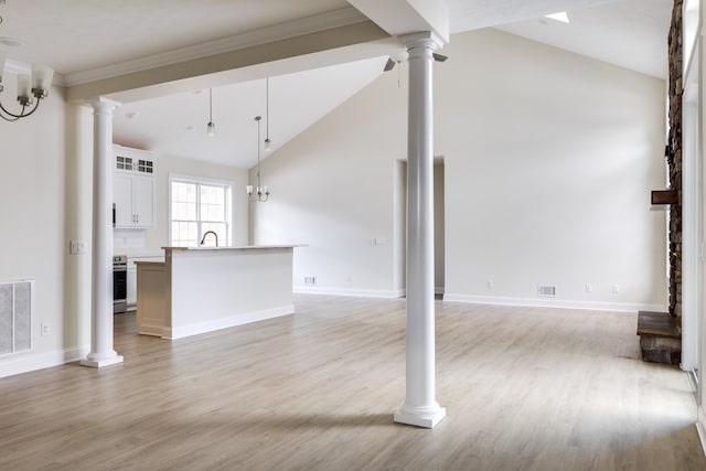 unfurnished living room with ornate columns, high vaulted ceiling, sink, and light hardwood / wood-style floors