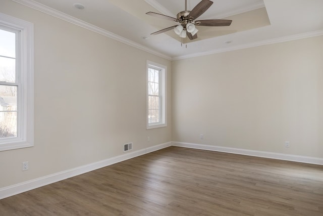 spare room with hardwood / wood-style flooring, ceiling fan, and crown molding