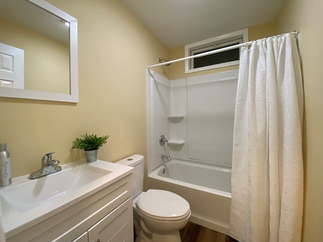 full bathroom featuring vanity, shower / tub combo, and toilet