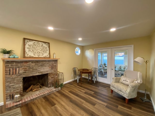 living area featuring dark hardwood / wood-style flooring and a fireplace