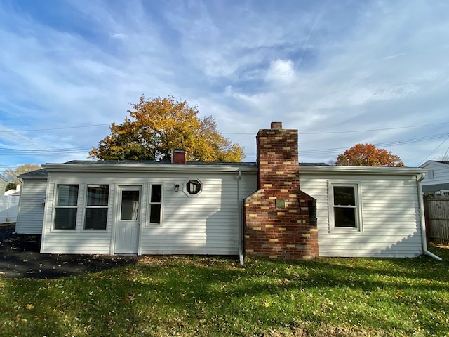 back of house with a lawn