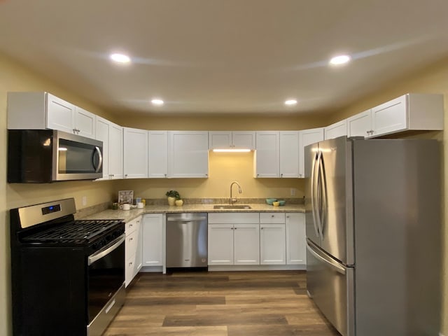 kitchen with white cabinetry, appliances with stainless steel finishes, and sink