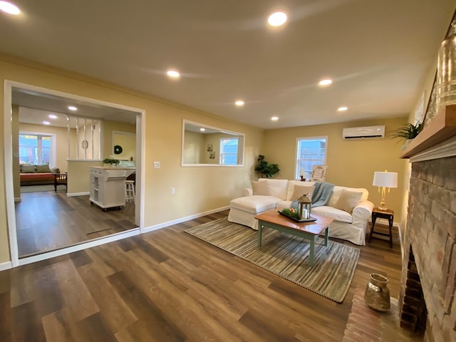 living room featuring a wall mounted air conditioner and dark hardwood / wood-style floors