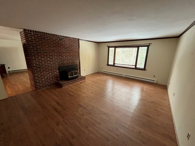 unfurnished living room featuring ornamental molding, light hardwood / wood-style floors, and a baseboard heating unit