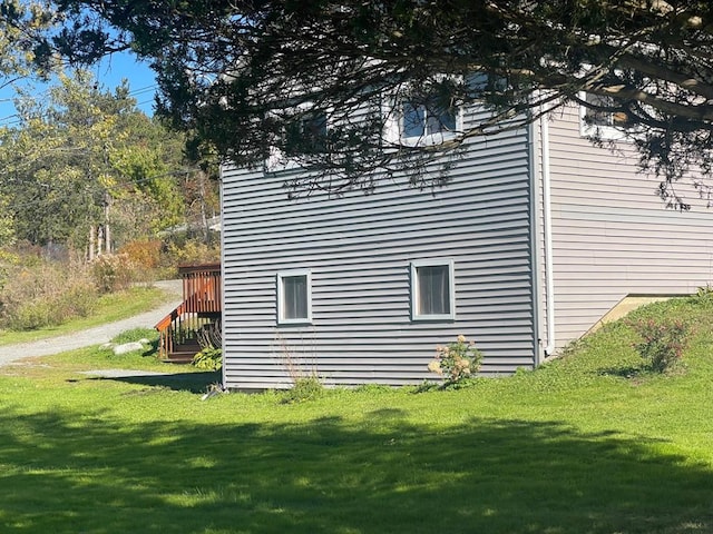 view of side of property with a lawn