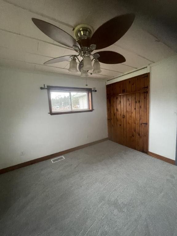 unfurnished bedroom featuring a closet, ceiling fan, and carpet