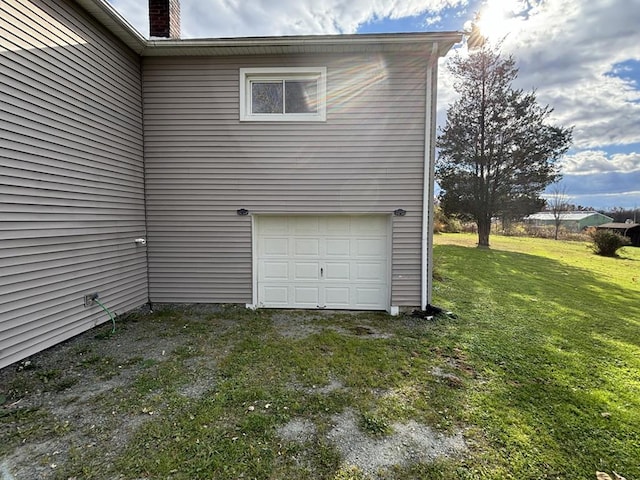 garage featuring a lawn