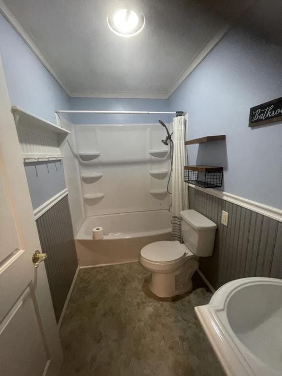 bathroom featuring toilet, wood walls, crown molding, and shower / bath combo with shower curtain