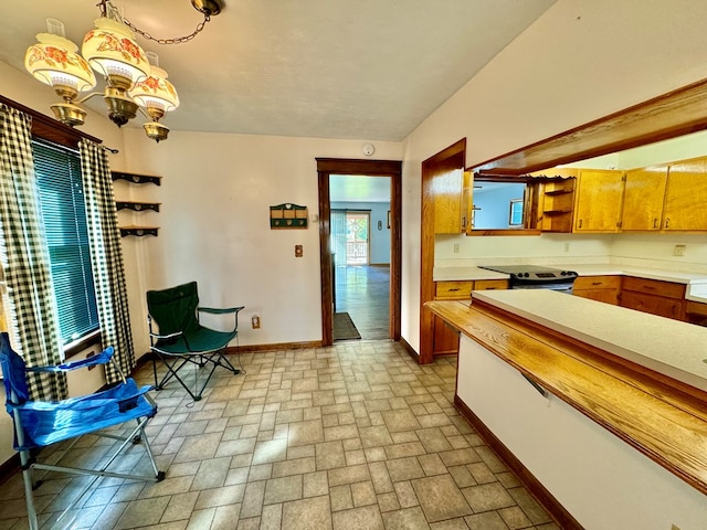 kitchen featuring pendant lighting and a notable chandelier