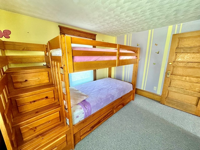 bedroom featuring light colored carpet and a textured ceiling