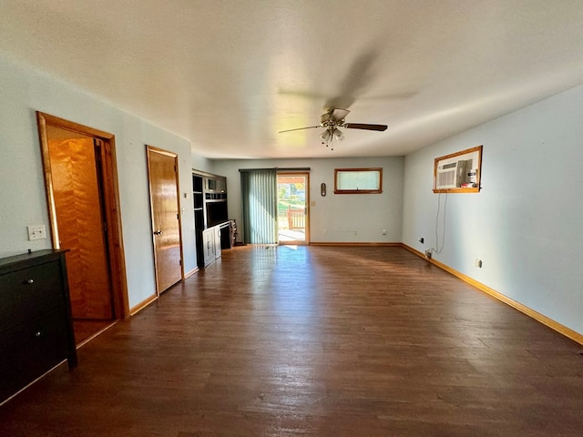 interior space featuring an AC wall unit, dark wood-type flooring, and ceiling fan