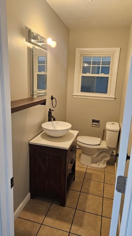 bathroom featuring tile patterned flooring, vanity, and toilet