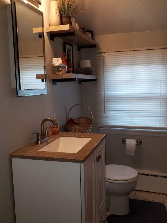 bathroom featuring vanity, a baseboard radiator, tile patterned floors, and toilet