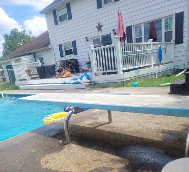 view of pool with a wooden deck and a patio area