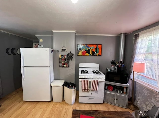 kitchen featuring white appliances, light hardwood / wood-style flooring, and ornamental molding