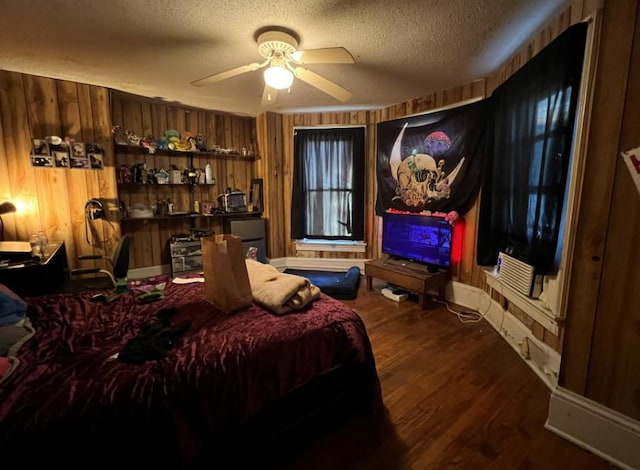 bedroom with hardwood / wood-style flooring, a textured ceiling, and wood walls