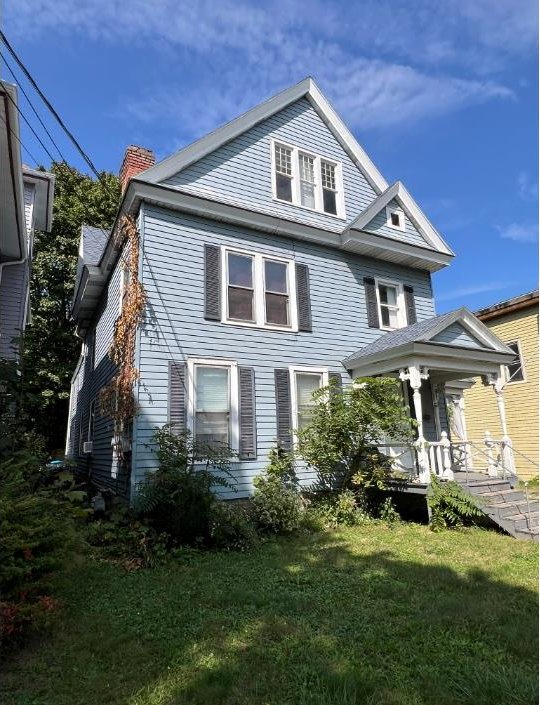 view of side of property with a yard