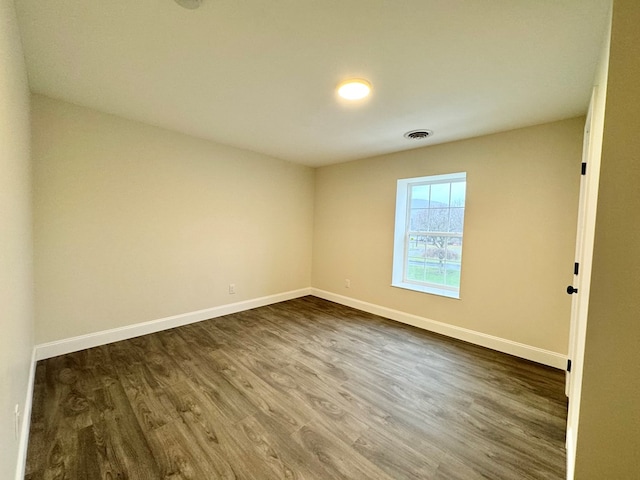 spare room featuring dark hardwood / wood-style floors