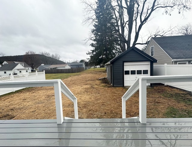 view of yard with a garage and an outdoor structure