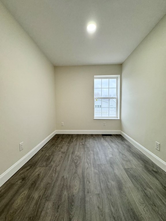 empty room featuring dark hardwood / wood-style floors