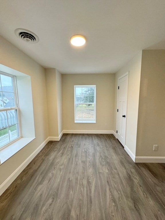 spare room with dark hardwood / wood-style flooring