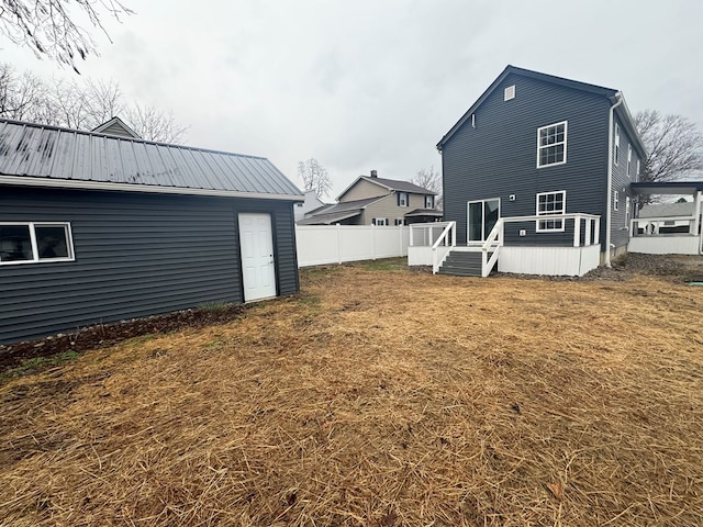 rear view of property with a lawn and a deck