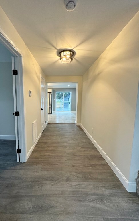 hallway with dark hardwood / wood-style flooring