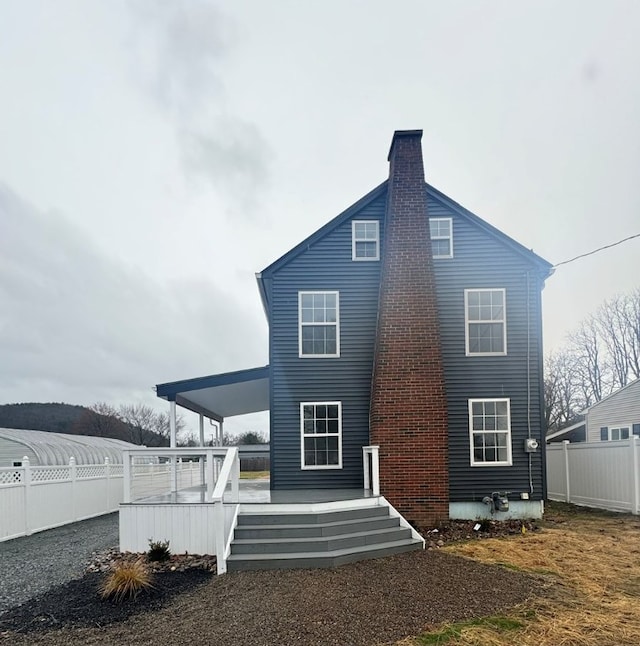 rear view of house featuring a deck