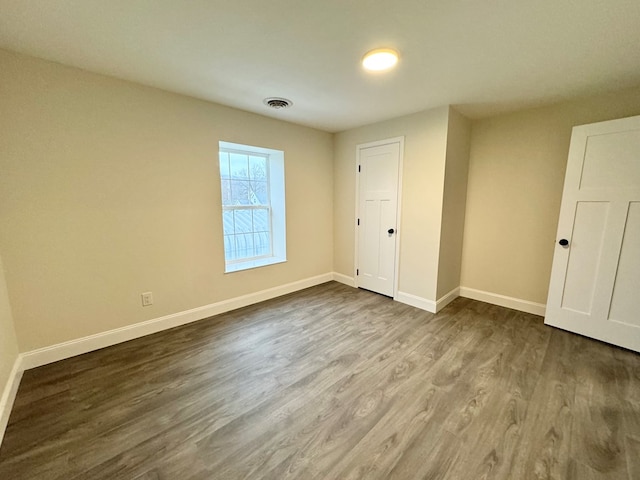 unfurnished bedroom featuring hardwood / wood-style floors