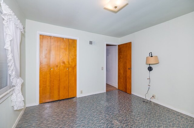 unfurnished bedroom featuring a closet