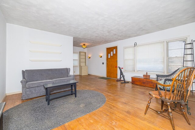 living room with a textured ceiling and light hardwood / wood-style floors