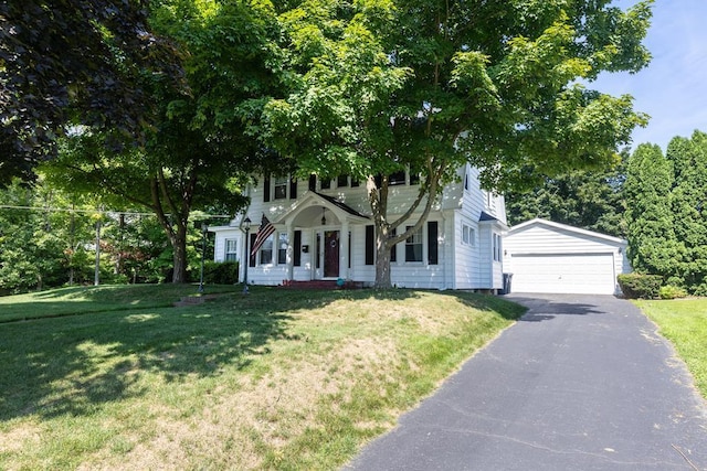 colonial home featuring a garage and a front yard