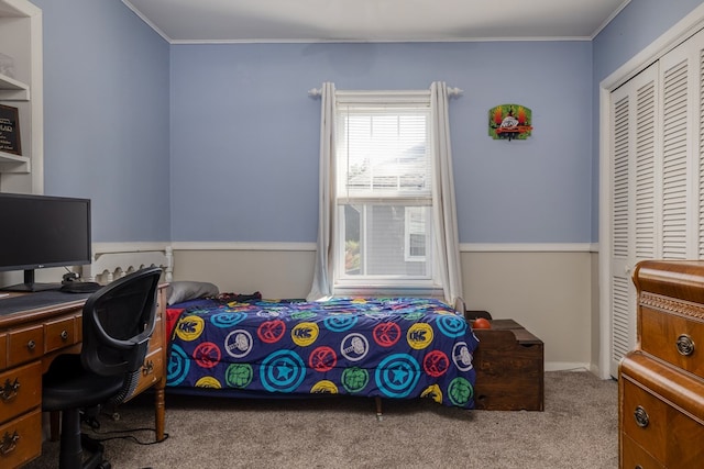 bedroom featuring light carpet, ornamental molding, and a closet