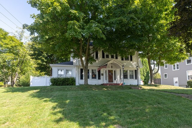 colonial-style house with a front lawn