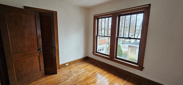 empty room with a healthy amount of sunlight and light hardwood / wood-style floors