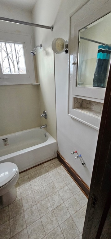 bathroom with bathtub / shower combination and toilet