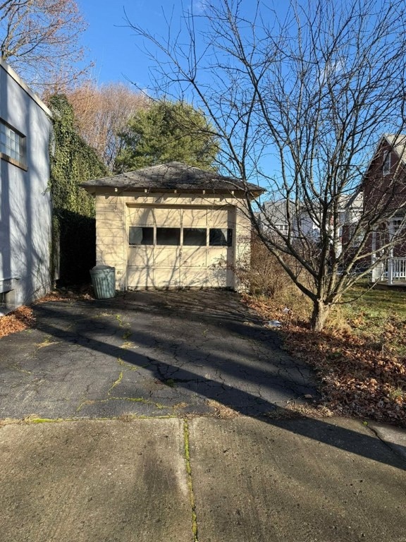 exterior space featuring a garage and an outdoor structure